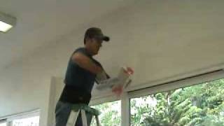 Applying a skim coat layer of drywall mud to a bullnose corner edge [upl. by Nayve]