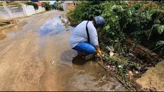 Remove weeds and debris from clogged drains Unclogging Culvert Drain Flooding​unclogging drain [upl. by Amehsyt]