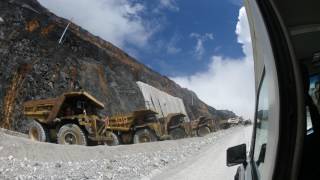 Line of overburden trucks waiting disposal  Grasberg Mine [upl. by Kryska]