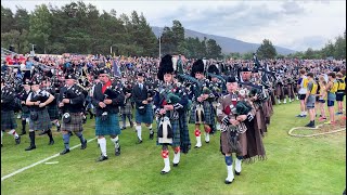 Massed Pipe Bands marching around Highland Games field during 2022 Braemar Gathering in Scotland [upl. by Bundy]