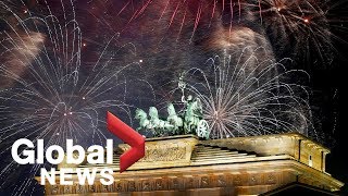 Revelers welcome the New Year at Berlins Brandenburg Gate [upl. by Ahsitneuq]