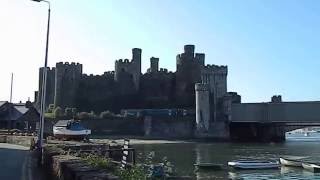 Train emerges from historic Conwy Railway Bridge next to Castle Wales UK [upl. by Isiah]