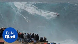 Surfers ride huge waves off the coast of Portugal in Nazare  Daily Mail [upl. by Reld]