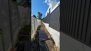 Colourbound fence on top of the concrete sleeper retaining wall fencebuilding fence fenceline [upl. by Ocana]