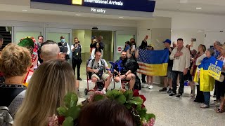 Crowd sings to wounded Ukrainian soldiers arriving in Minnesota to be fitted for prosthetic limbs [upl. by Cenac]