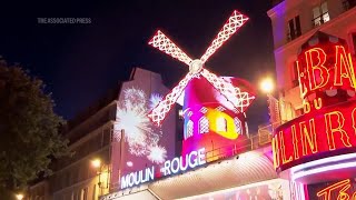 The Moulin Rouge cabaret in Paris has its windmill back after a stunning collapse [upl. by Llednar]