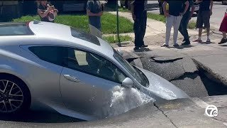 Car falls into sinkhole as street collapses in Southwest Detroit [upl. by Atnom335]