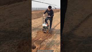 Drilling holes in the ground with a petrol drill [upl. by Mesics]