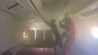 Aircraft Fire Evacuation and Fire Fighting Cabin Crew Training smoke filled cabin [upl. by Keraj]