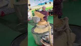 The process of grinding grains into powder with stone mills [upl. by Brigitta]