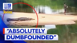 Footage of man fishing metres away from crocodile in Cairns  9 News Australia [upl. by Orodoet]