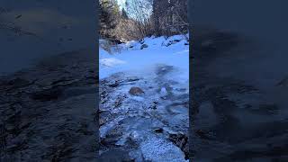 Frozen stream with a dust of snow Air bubbles dancing under the ice [upl. by Enitsirk285]