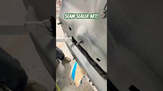 Laying seam sealer on this BMW after replacing the rear body panel seamsealer autobody collision [upl. by Norbie237]