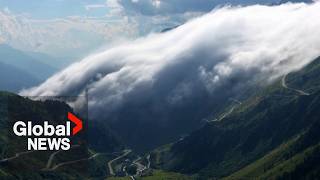 quotRiver of cloudsquot descends over Swiss Alps in stunning drone video [upl. by Clapper]