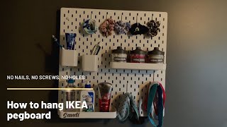 How to hang an IKEA pegboard without screws using Command Strips [upl. by Tnahsarp]