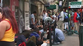 Dozens of migrants camp outside Roosevelt Hotel sign says hotel at capacity [upl. by Aihsemek393]