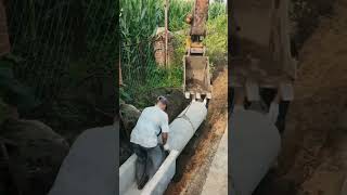 Rural workers laying concrete water pipe underground [upl. by Assiar]