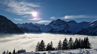 Snowy Swiss mountains with fog in the valley time lapse [upl. by Zebadiah]