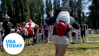 Husbands compete in wifecarrying contest  USA TODAY [upl. by Ezirtaeb548]