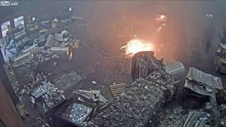 Foundry worker puts wet scrap metal in furnace [upl. by Ykcir]