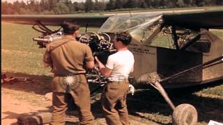 US Army aircraft mechanics repair a Stinson L5 airplane in Germany HD Stock Footage [upl. by Suoirred567]