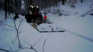 Harbor Springs Snowmobile Club testing Soucy track equipped John Deere pulling drag up STEEP hill [upl. by Ettesil]