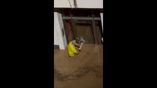 Man smashes glass door to save children in Spanish floods [upl. by Alba]