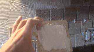 How to install stone tile on a kitchen backsplash  DIY [upl. by Hulen]