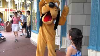 Pluto signing an autograph book at Disney Worlds Magic Kingdom [upl. by Navonod]